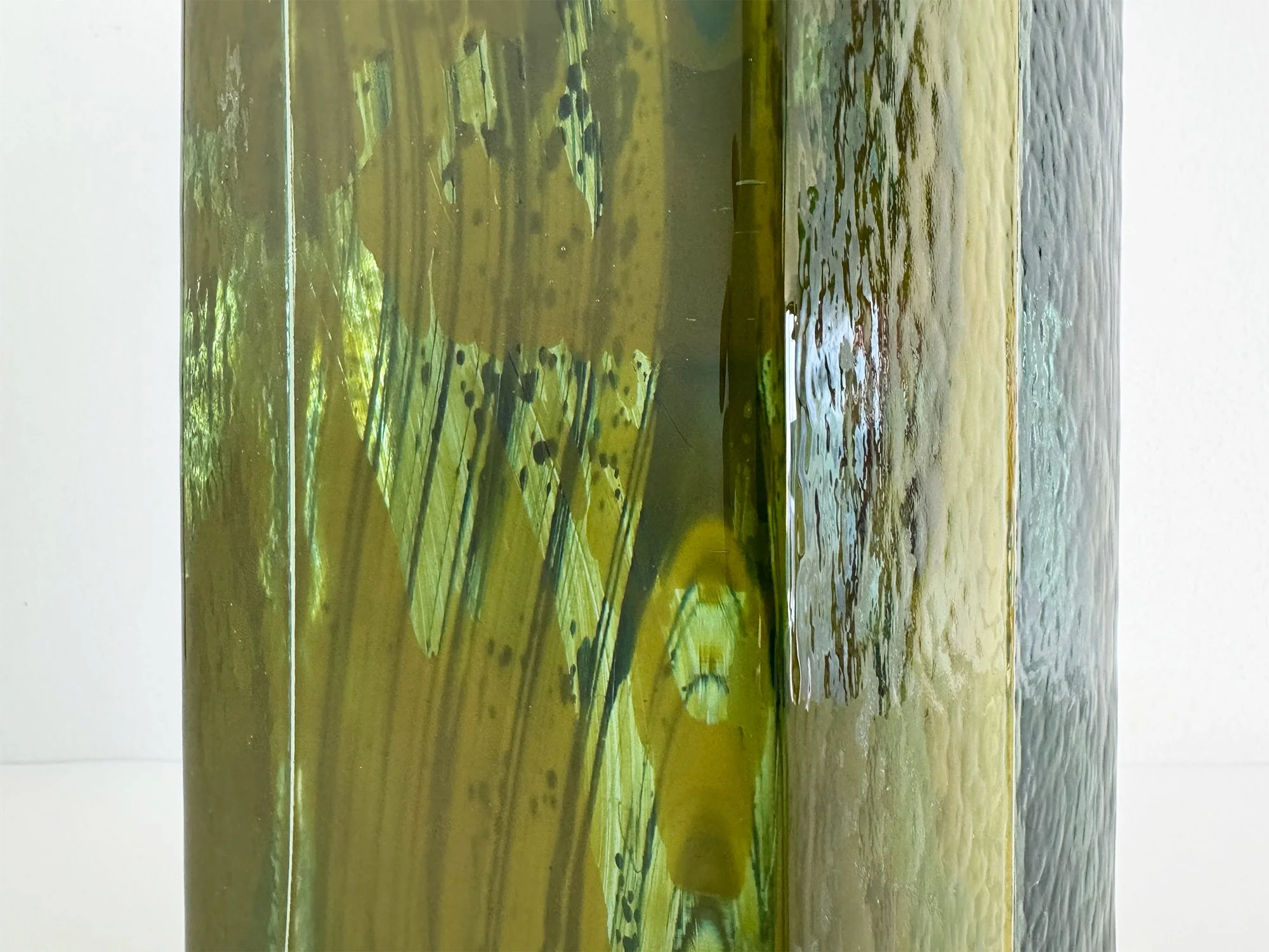 Close-up of handcast glass sculpture by Lisette Schumacher showing reflections and glass texture