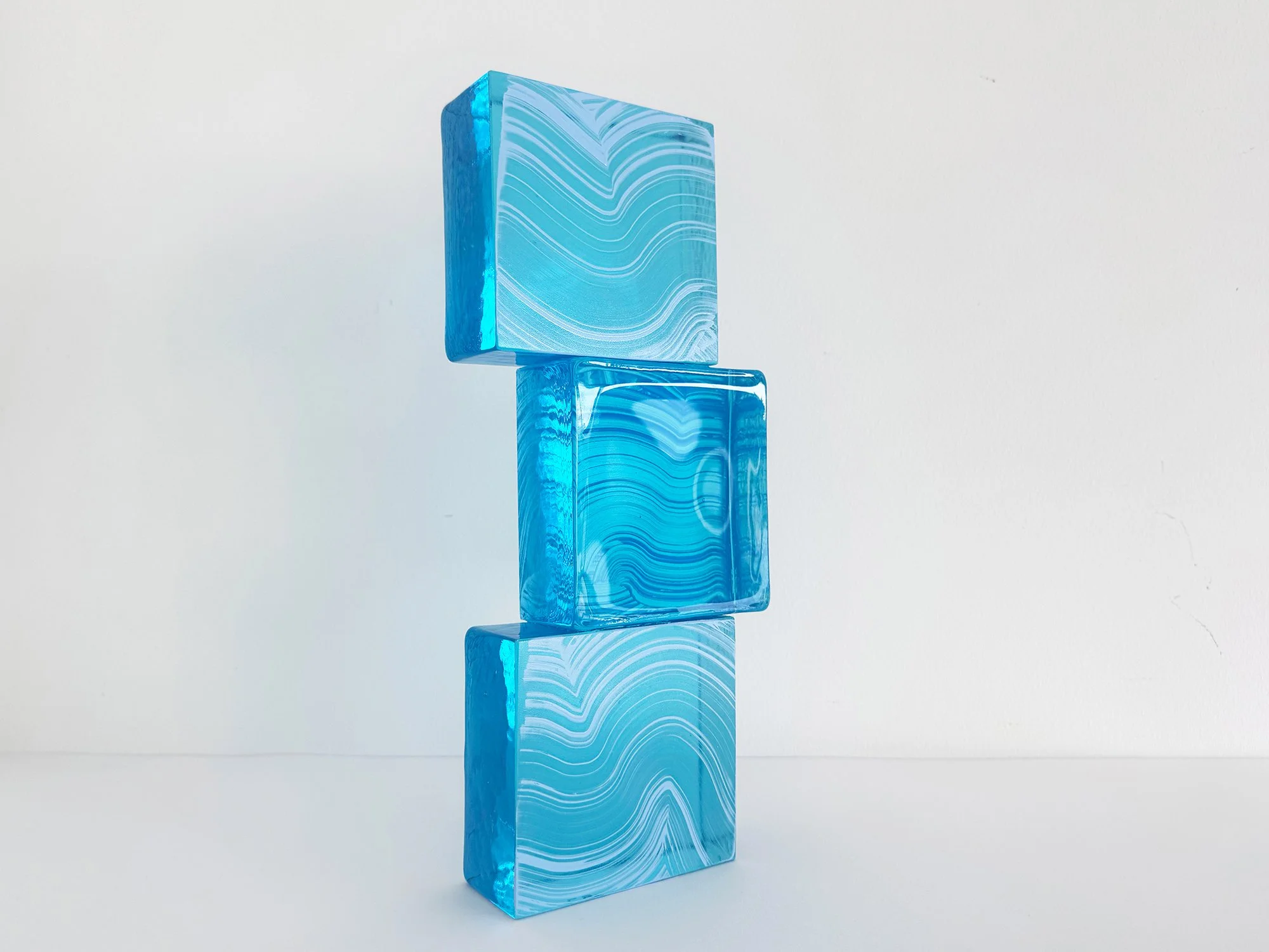 Modern collectible glass sculpture in blue tones inspired by architectural brick forms