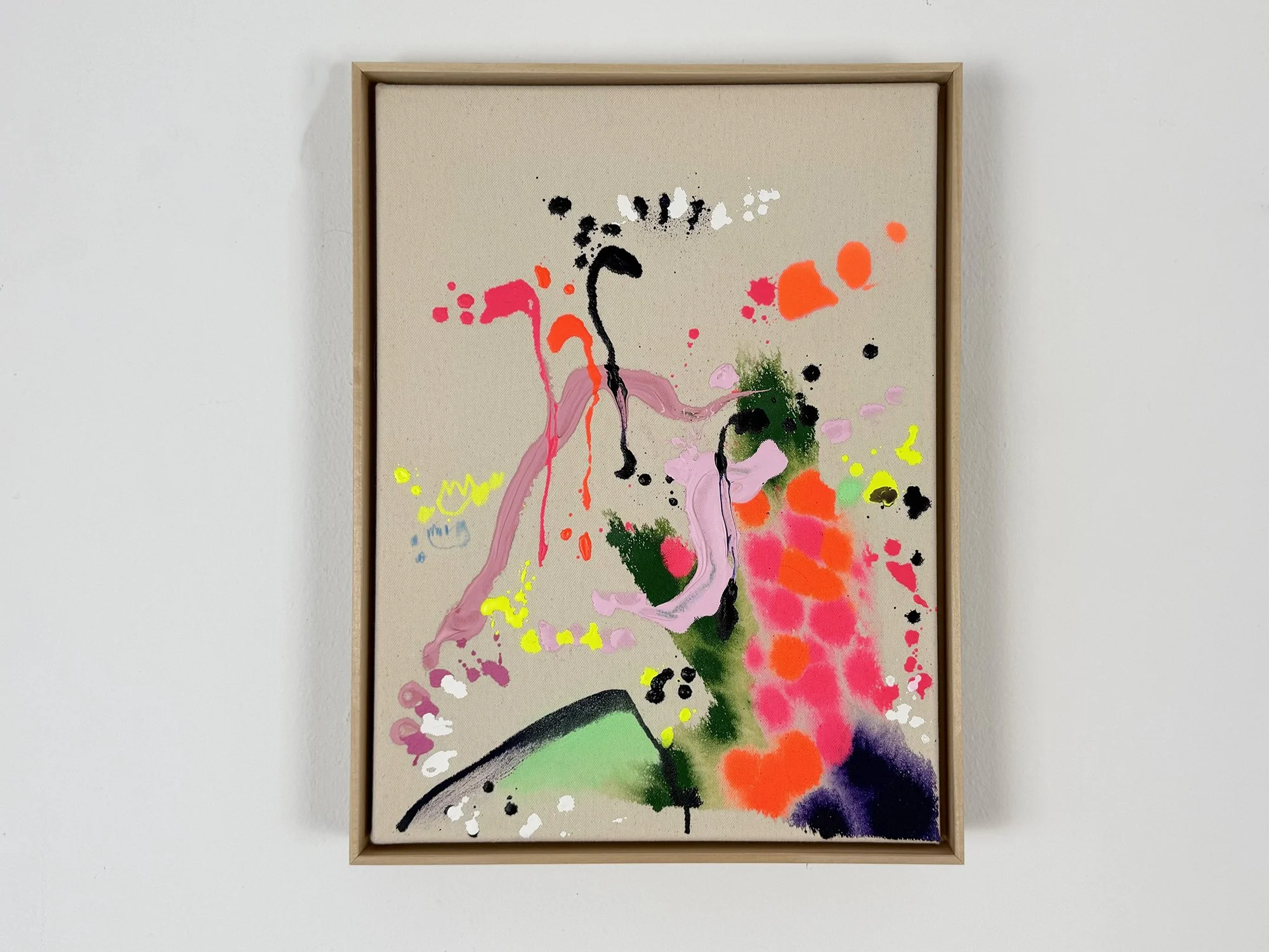 Abstract mixed media painting by Vera Klaus with vibrant pink, orange and green paint marks on raw canvas, shown in a wooden frame on a white wall.