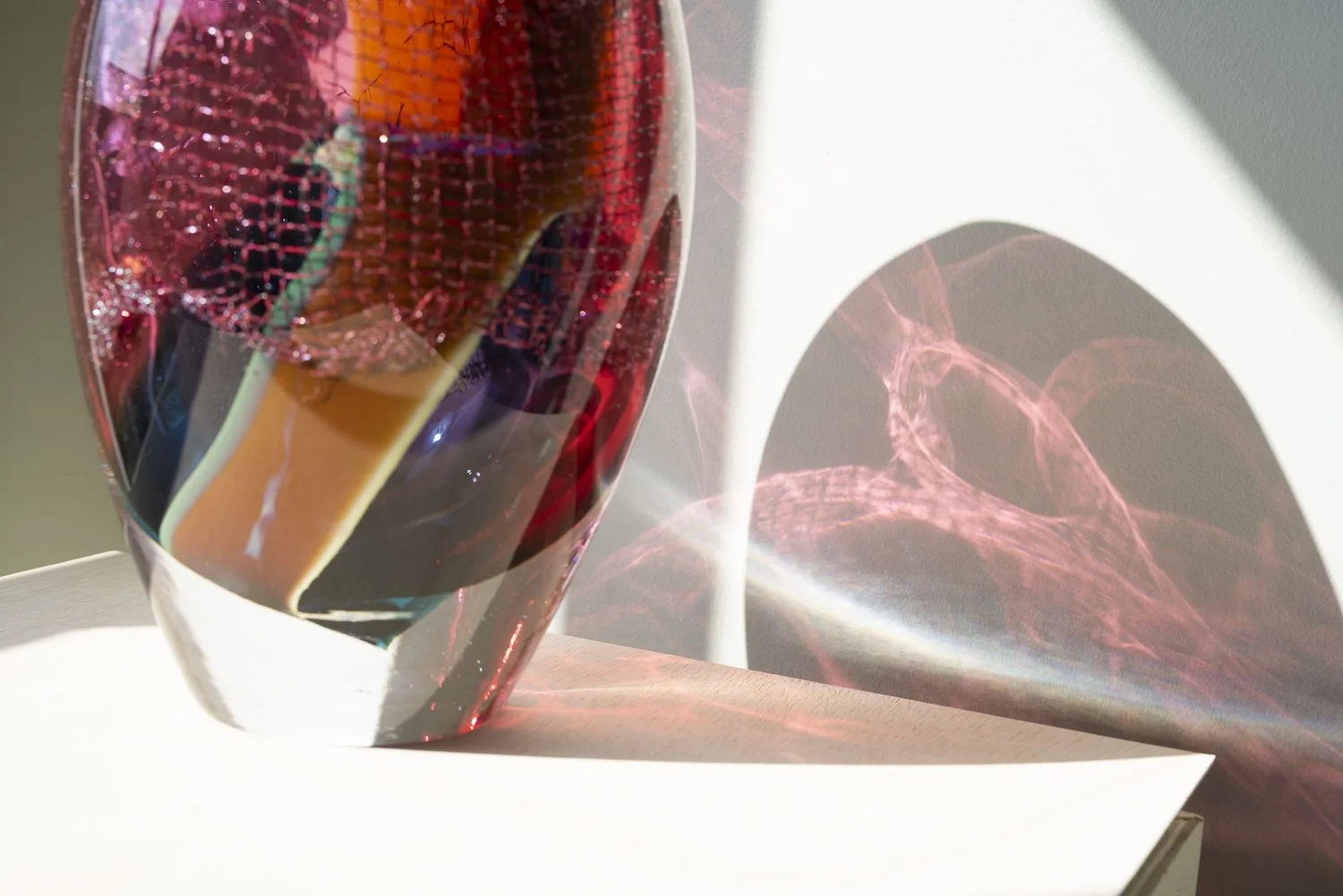 Detail of copper mesh visible through red glass in Crystal Clear #11 by Francisca Snel.