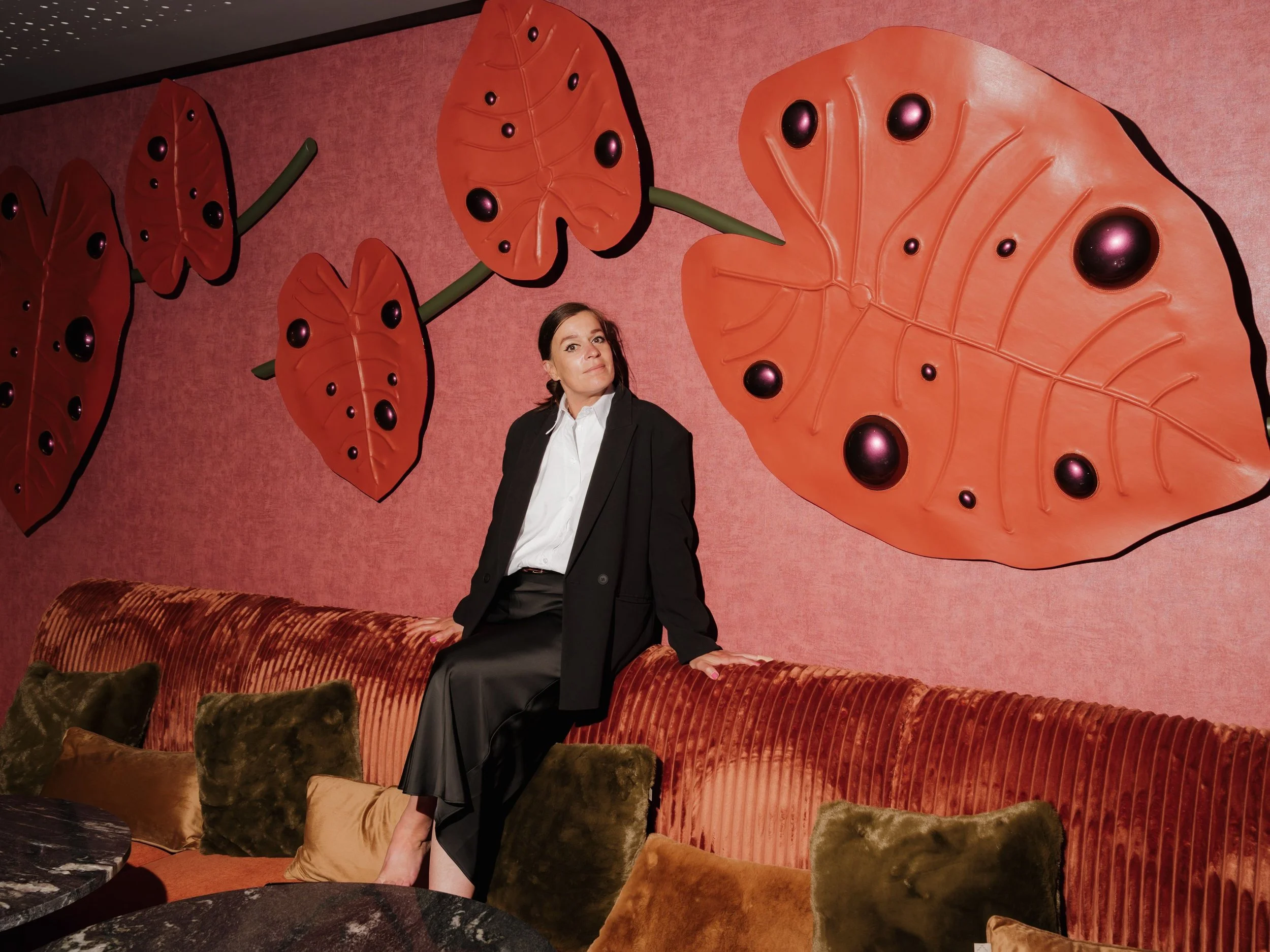 Portrait Dutch artist Madelon Uljee next to her large installation created for a hotel in Amsterdam.