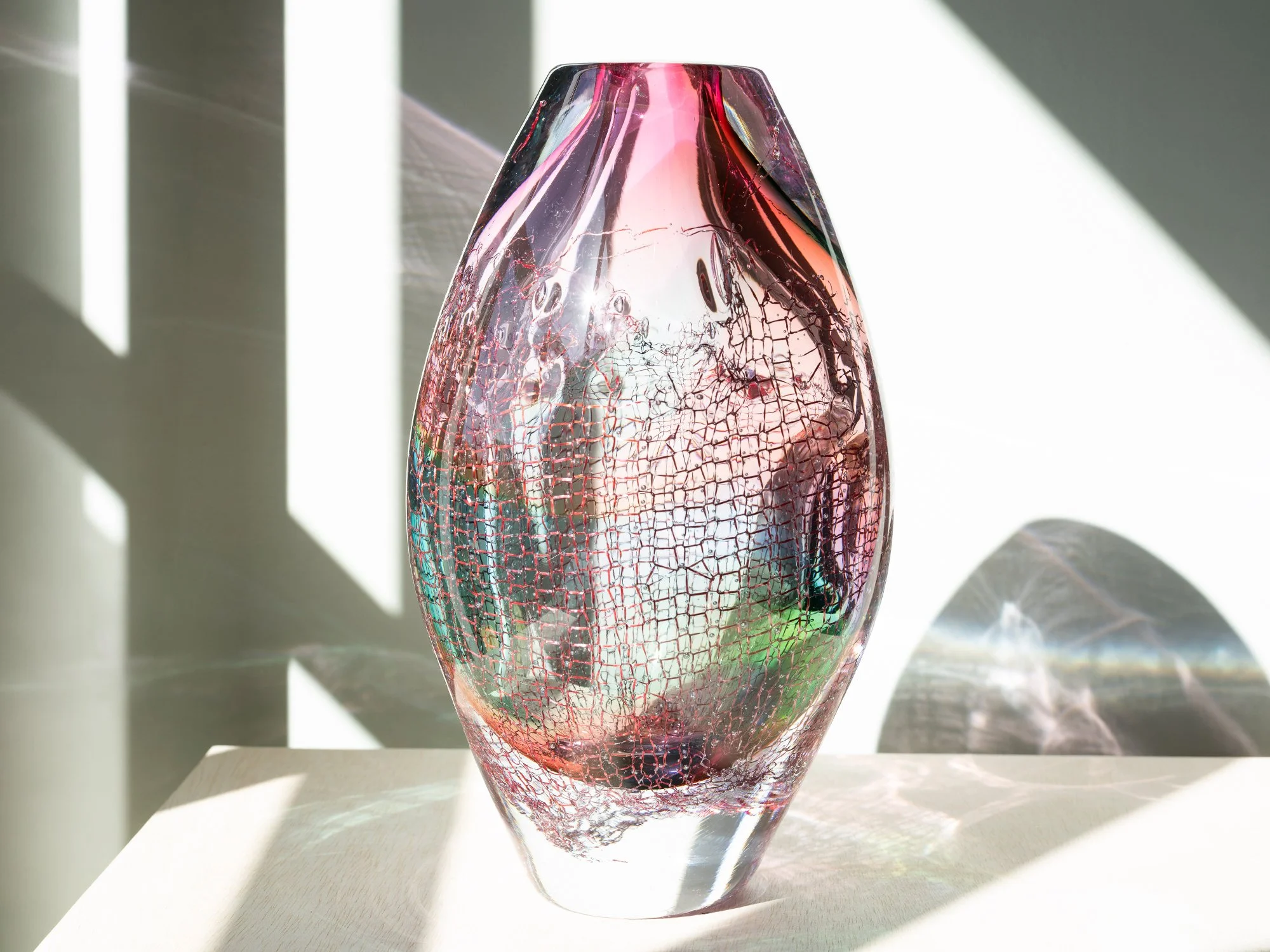 Contemporary pink glass sculpture by Francisca Snel with subtle green tones and embedded copper