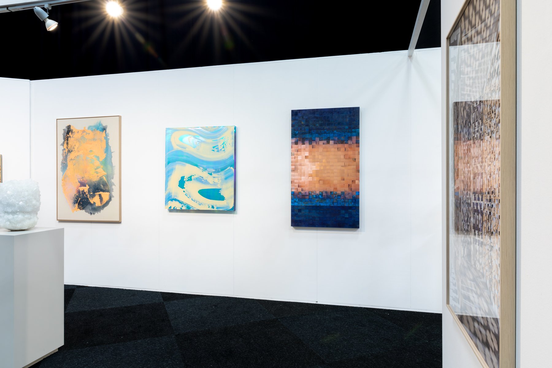Karen van de Vliet’s Faling Safely to the Ground displayed in a group booth at an art fair, surrounded by other contemporary artworks in a professional art fair setting.