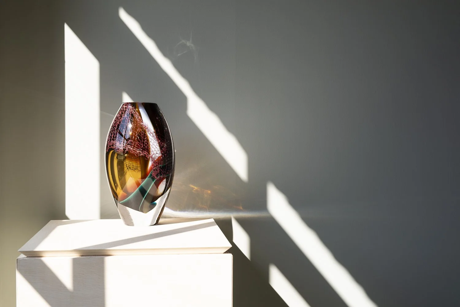 Crystal Clear #14 by Francisca Snel, a reddish-brown glass sculpture with prominent copper mesh and turquoise and amber accents.