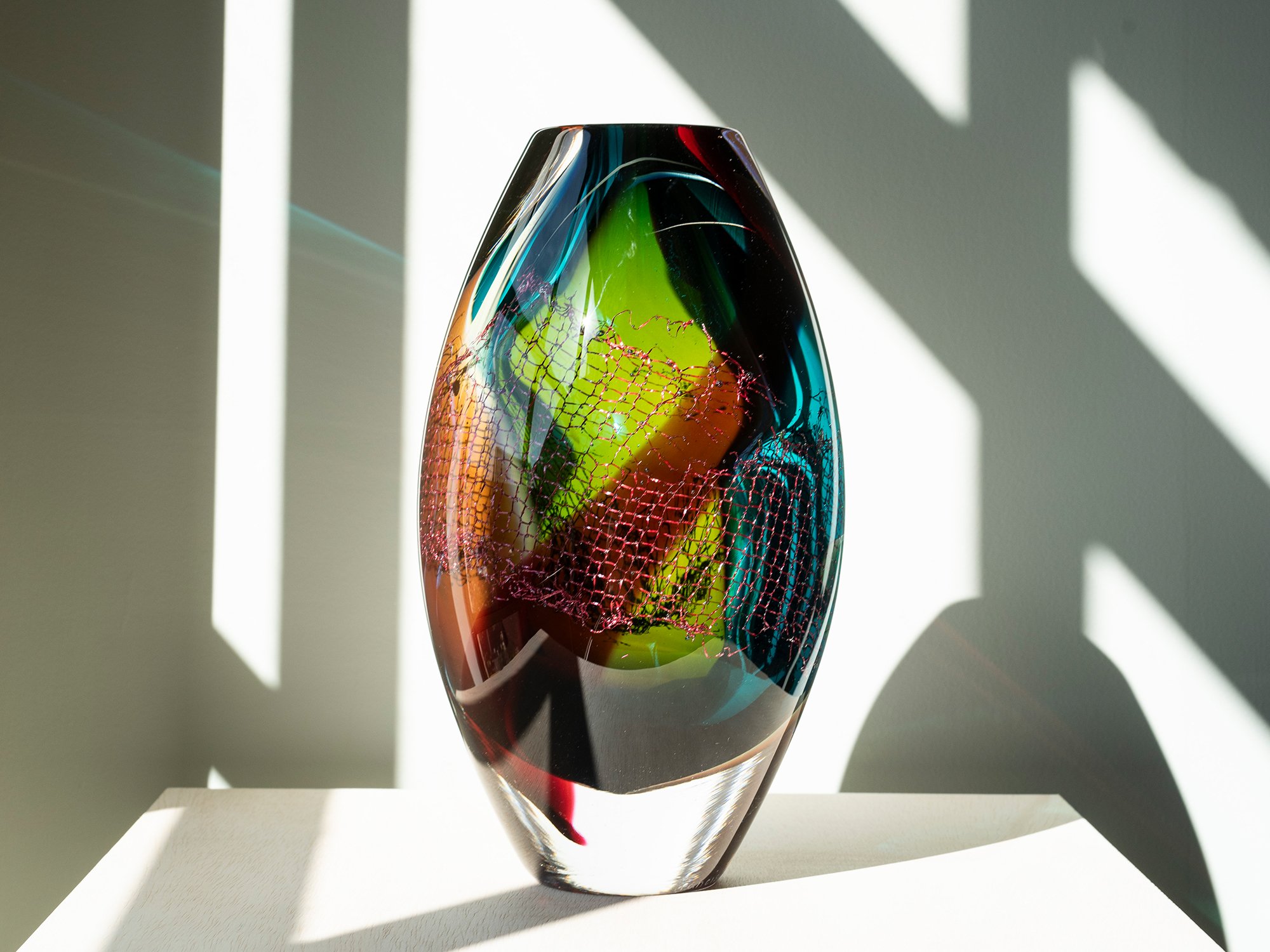 Colourful glass and copper sculpture by Francisca Snel with turquoise, green, amber and red glass