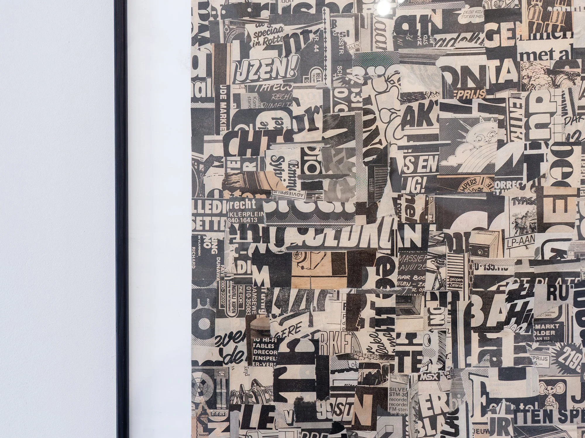 Detail of Saïd Kinos’s Static001, showing overlapping black-and-cream lettering and fragments of printed text.