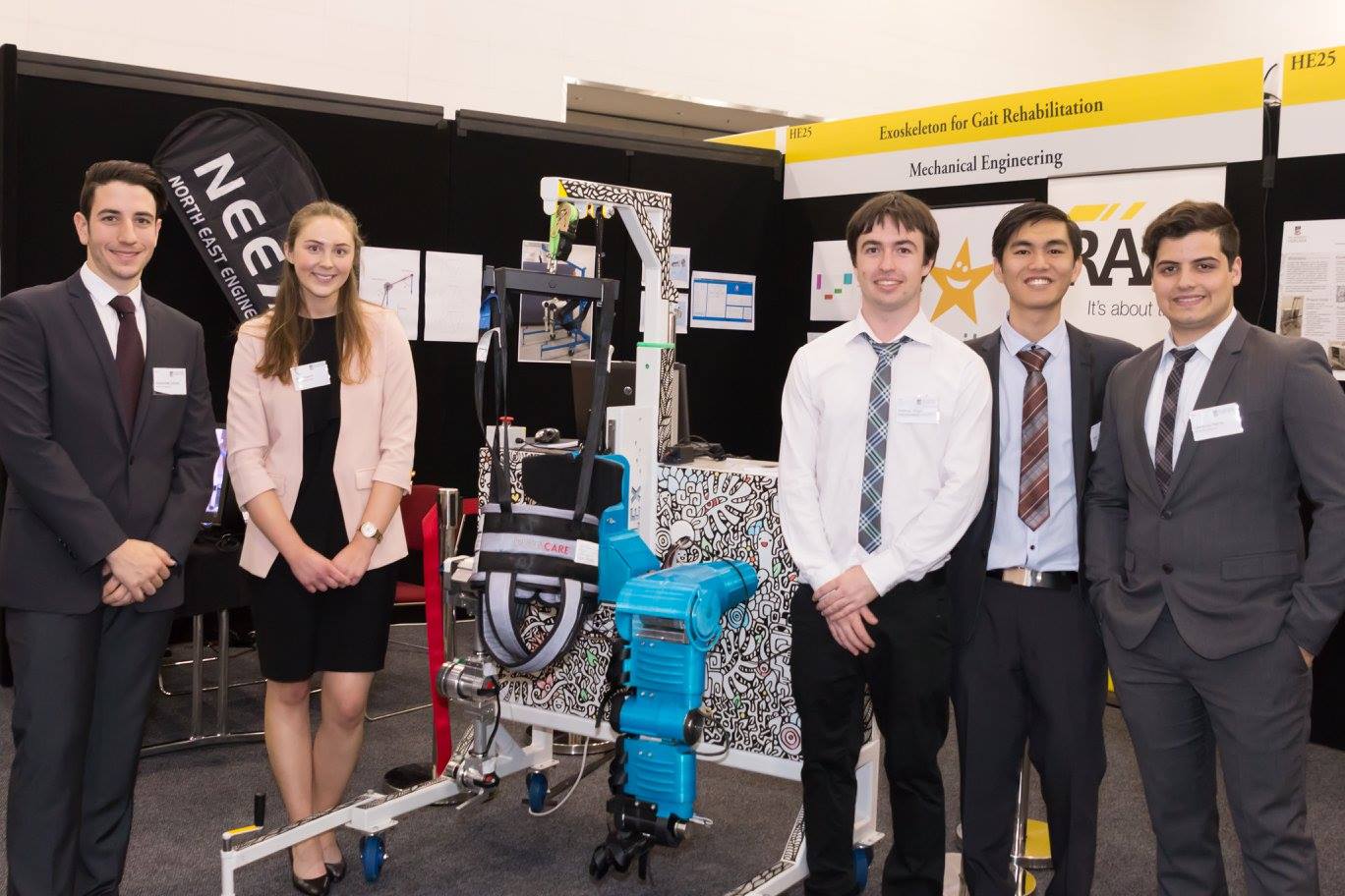Booth 2045 at Ingenuity 2016, mechanical engineers with robotic exoskeleton featuring Azz's artwork