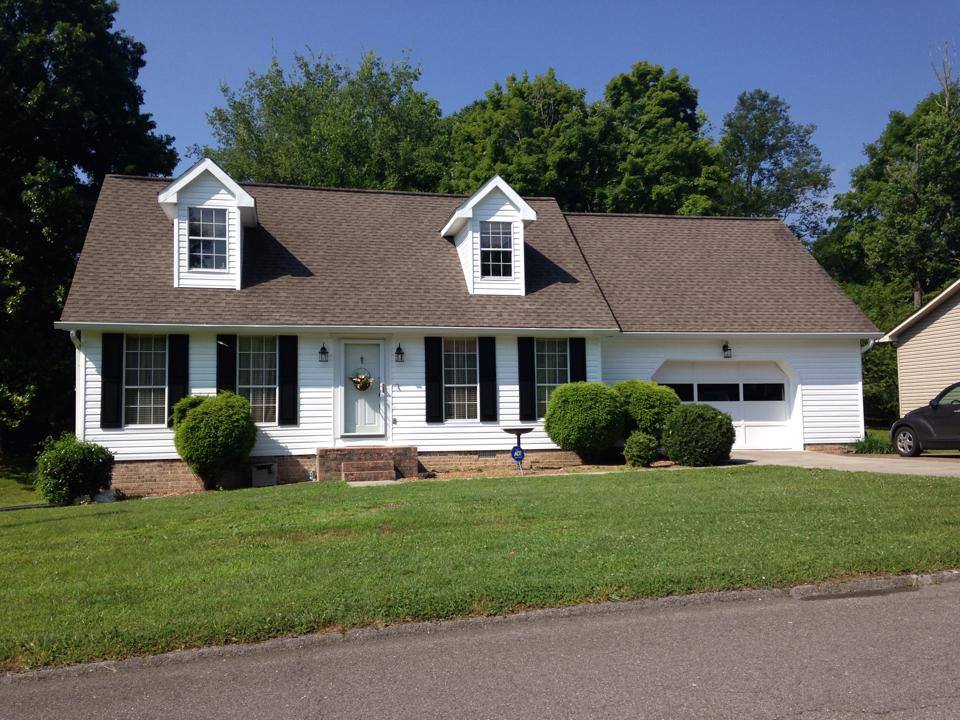 white vinyl siding and driftwood shingle roof