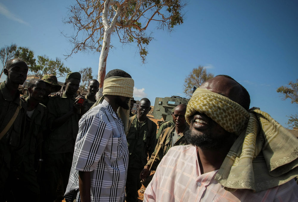 Suspected members of al-Shabaab under guard in Kismayo shortly after its recapture by Kenyan, Somali and Ras Kamboni forces, October 2012. Photo: UN Photo/Amnisom/Stuart Price