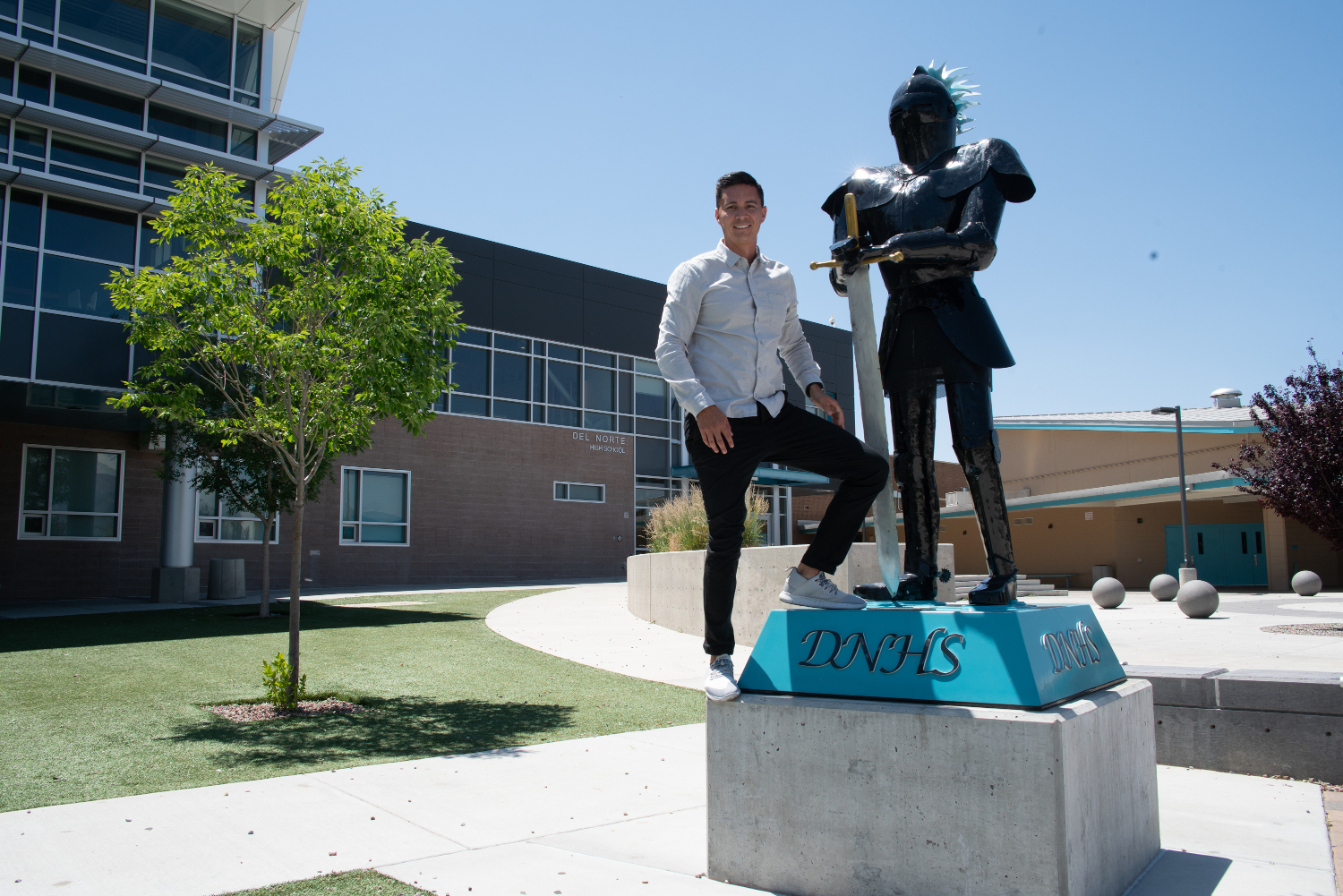 Seth Saavedra stands outside Del Norte High School in Albuquerque. He dropped out when he was a senior and ended up getting his GED two years later . Don Usner / Searchlight New Mexico.