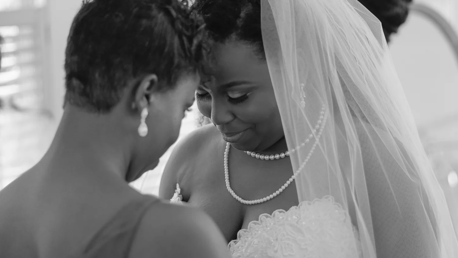 bride and  bridesmaid praying
