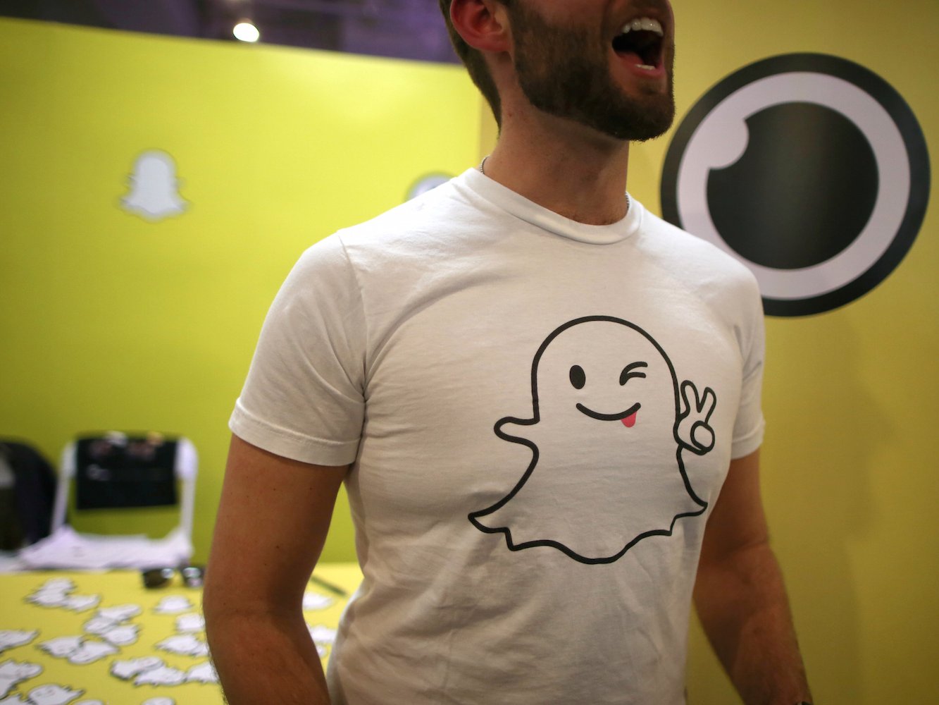 A recruiter for messaging app Snapchat talks to job seekers at a booth at TechFair LA, a technology job fair, in Los Angeles, California, U.S., January 26, 2017. REUTERS/Lucy Nicholson