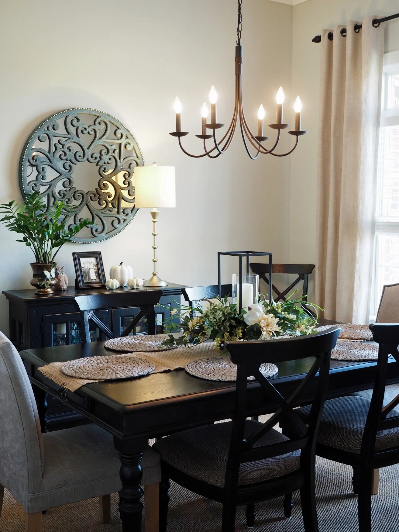 The formal dining room has maintained a fresh, neutral style for fall with bright green greenery and white pumpkins. Not many sources for this room because the mirror has been discontinued from Pier 1 Imports and the table and chairs are older and were purchased locally. The lamp is from Home Goods and the curtain panels are from Pier 1 Imports .