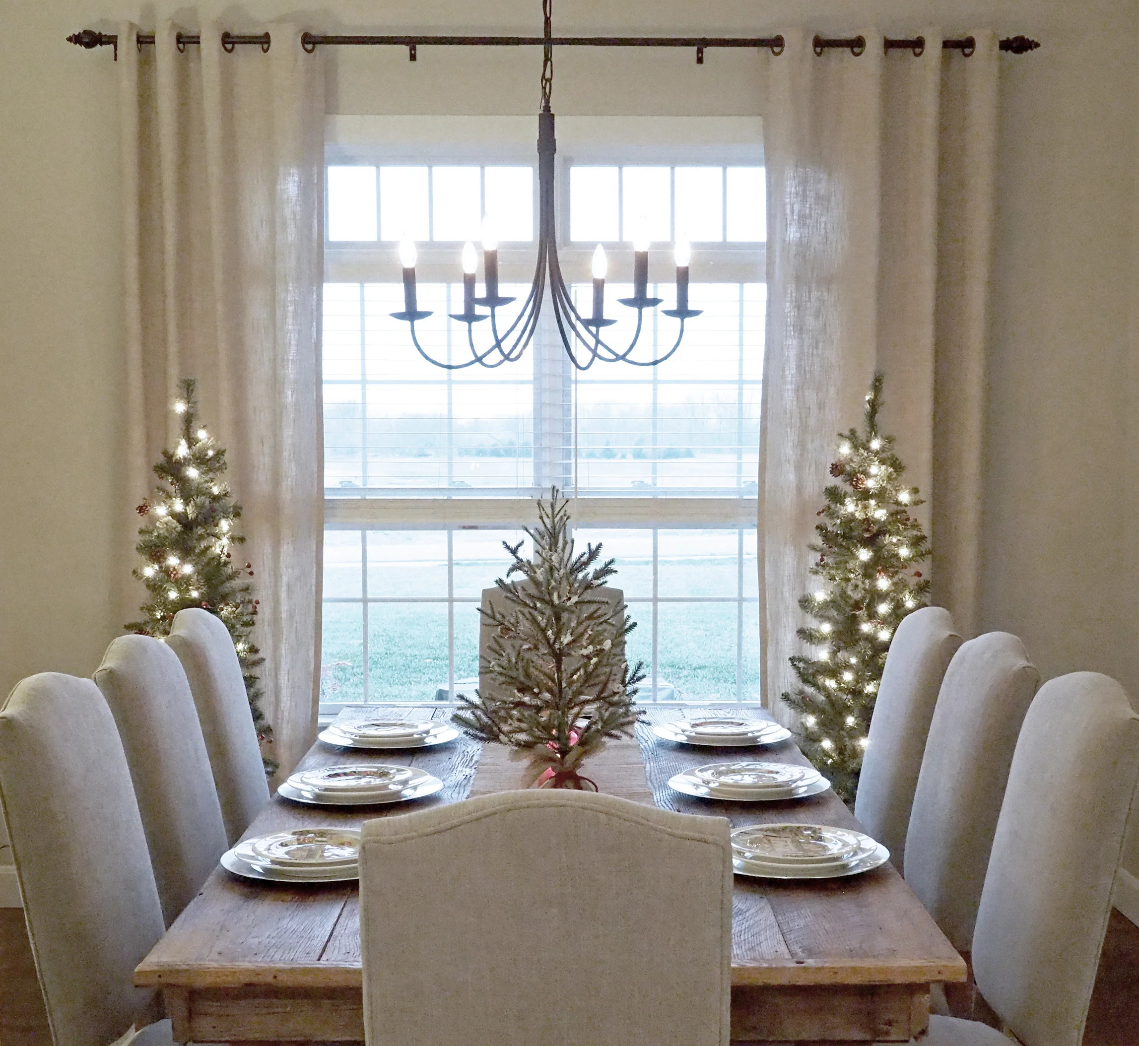 The Pottery Barn chairs fit comfortably around the table. Curtain panels are from Pier 1 Imports . 