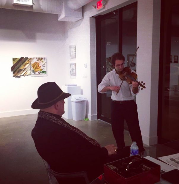 The artist Nall's opening reception February 11, 2016 at Octavia Art Institute Houston. The artist Nall listening to Matthew Madonia play the violin for guests.