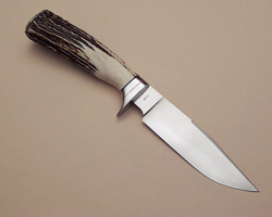 I forged this knife from 1095 tool steel.It has a differential heat treat causing a striking hamon. The 5" clip-point blade has a full flat grind with a convex edge, hand rubbed to 1200 grit. The guard and buttcap are 416 stainless with copper spa