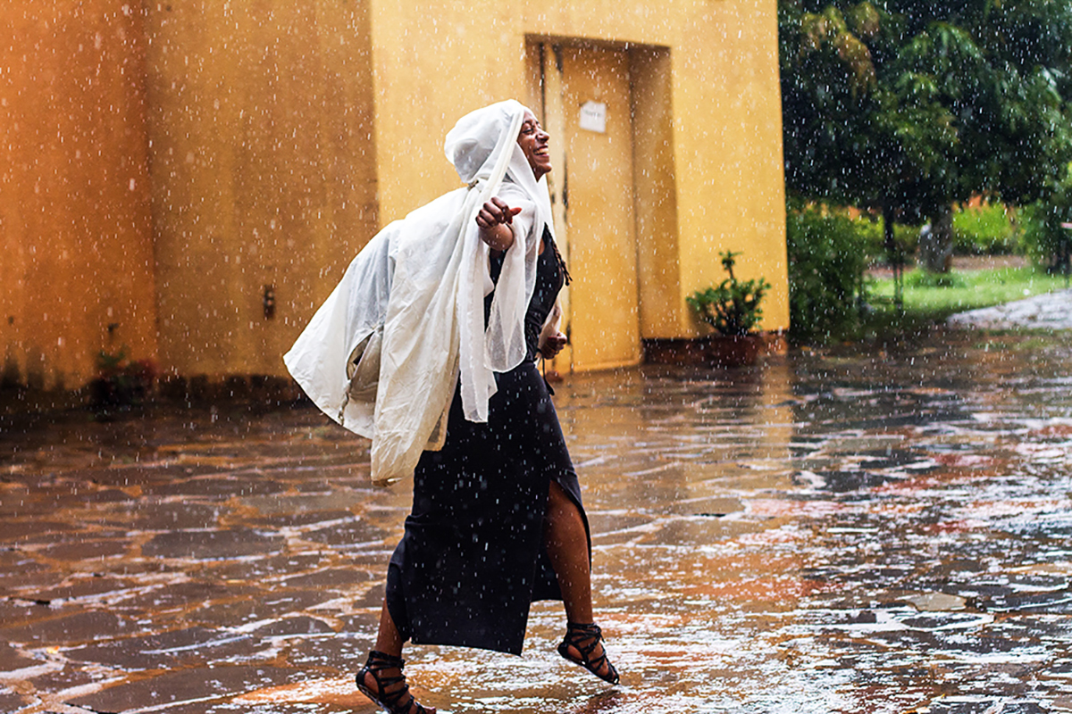   Katarina Hedrén, a film programmer and freelance writer, dances in the rain at the Bamako Encounters in Mali, 2015.  