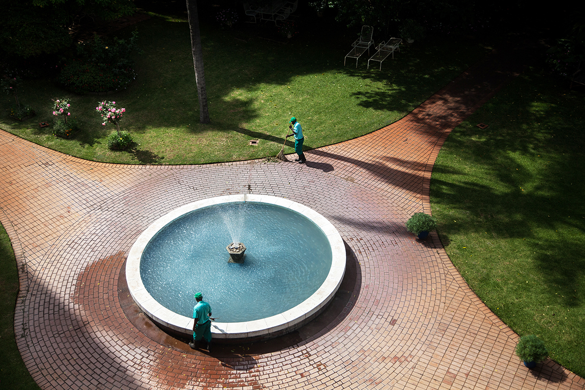 January 3, 2018: Workers at an apartment complex in the Avenues area of Harare tend to the building’s gardens. - For Deutsche Welle