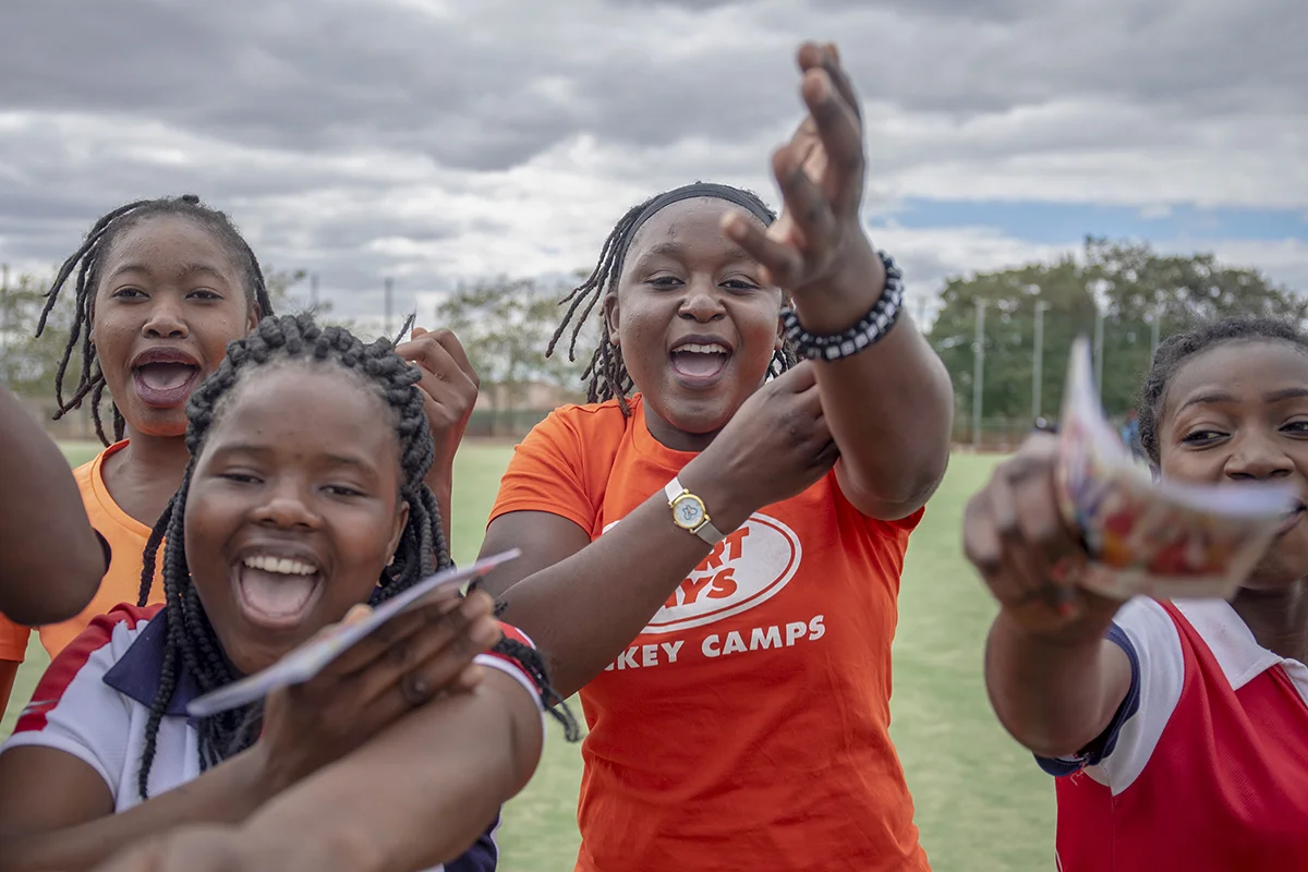 Esther Mwale, a teen connector at Marie Stopes Zambia’s Divine Diva Centre, celebrates with her hockey teammates. - For Marie Stopes International UK