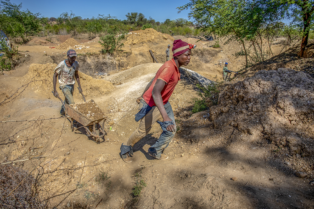 November 10, 2018: Artisanal miners transport a barrow full of ore from a shaft at Ngaka, Umguza district in Matabeleland North province 484 kms from Zimbabwe’s capital city, Harare. According to Zimbabwe National Statistics, mining accounts for 50% of the country’s forex earnings. - For Bloomberg