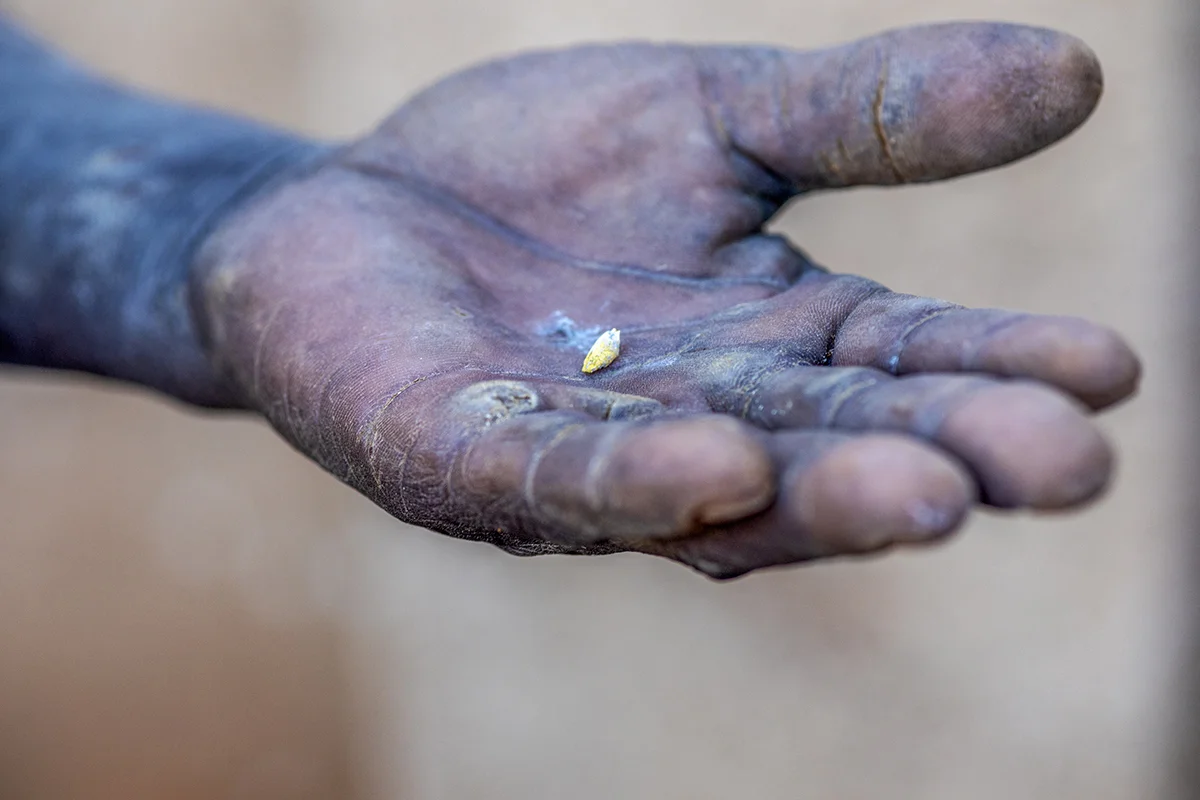 November 10, 2018: An artisanal miner holds a small ball of gold at Ngaka, Umguza district in Matabeleland North province 484 kms from Zimbabwe’s capital city, Harare. According to Zimbabwe National Statistics, mining accounts for 50% of the country’s forex earnings. - For Bloomberg
