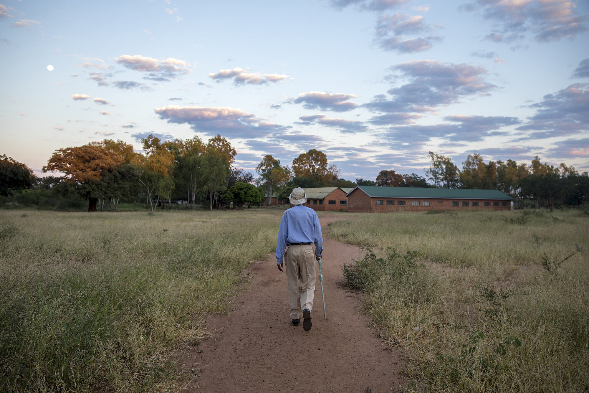  Every morning William Phiri walks to a nearby catholic church in his community to attend mass. He believes God protects us all in our daily lives.  