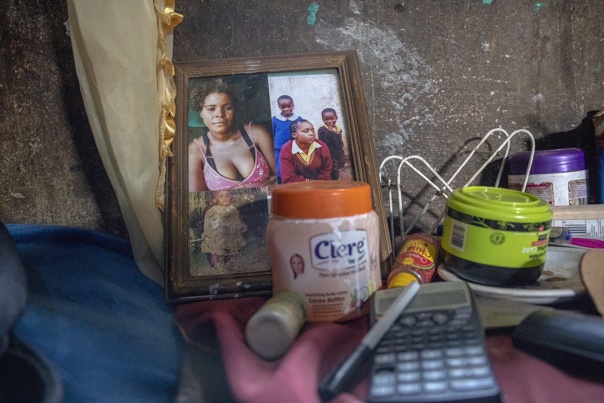  October 22, 2018: Pictures of Roselyn’s family are displayed at her home on the farm compound. Roselyn is a single mother who takes care of her four children with the money that she earns as a general hand in the flower grading shed. 