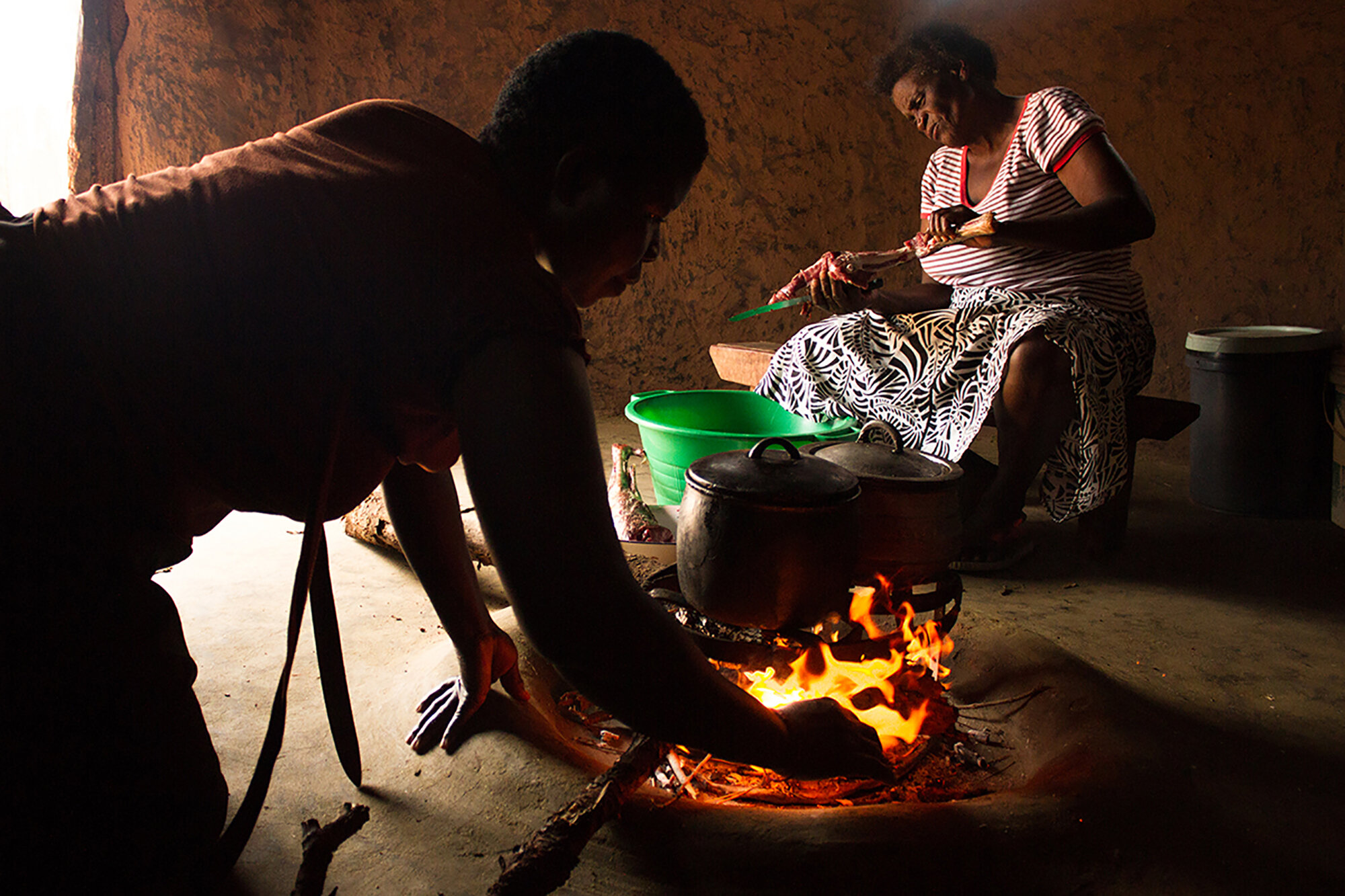  January 17, 2015: Gogo Mpofu makes goat meat for her grandchildren when she visits them at the beginning of the school term at the family rural home in Nkone, Nkayi in Matabeleland North. When she is back at work in Harare Gogo always jokes that, “O