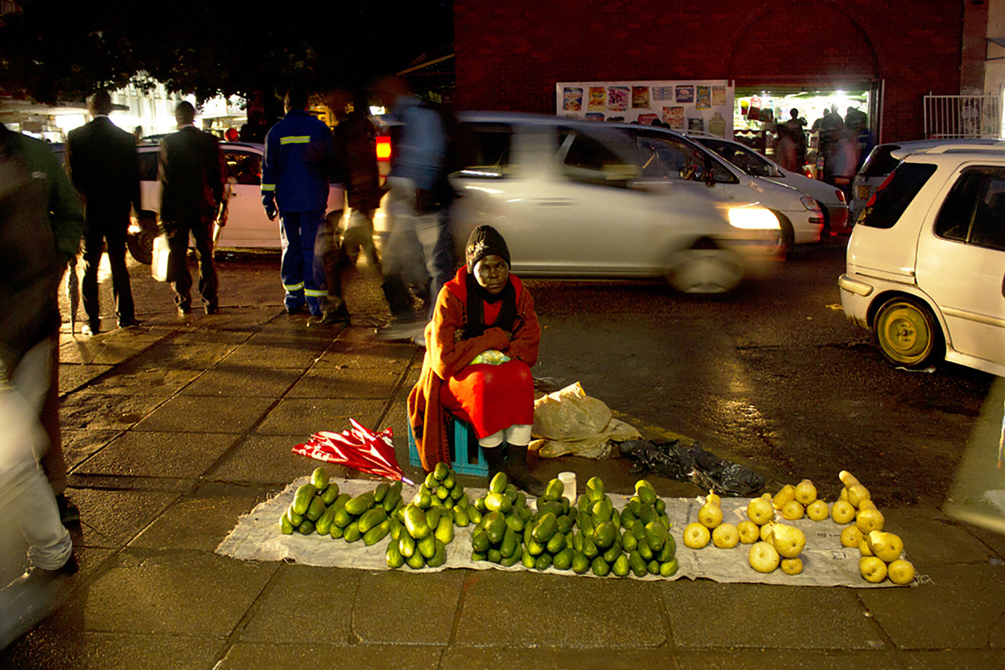 November 18, 2014: Duduzile Ncube waits for customers on a cold night in Harare. “I work my hardest for my children even when it is raining because I don’t want them to end up street kids or herd boys in the rural areas. They will end up blaming me,