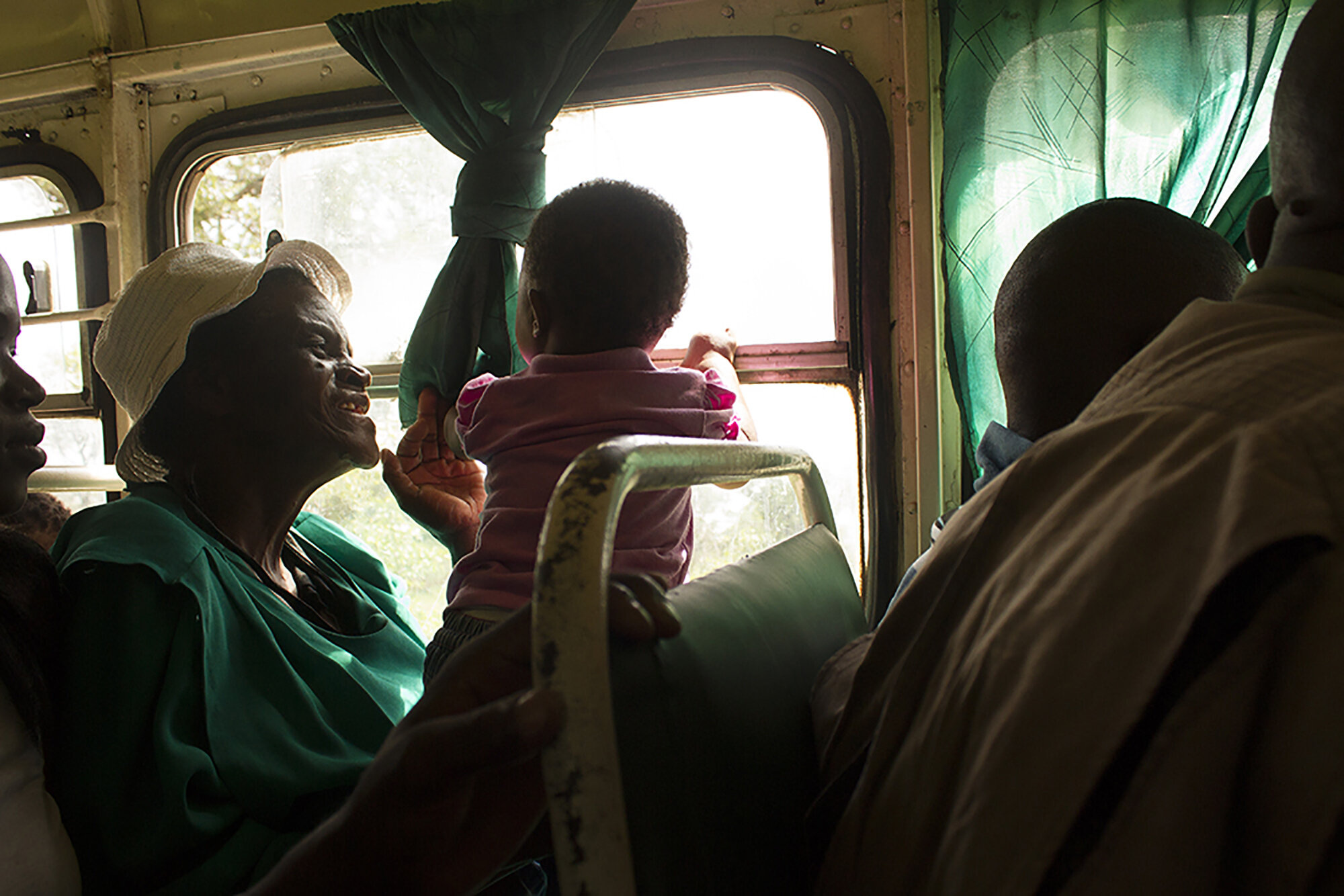  January 14, 2015: Gogo Mpofu plays with her first great grandchild on her way to Nkayi to visit her granddaughters. She travels the 617km route from Harare to Nkone, Nkayi two weeks before the school term begins and stays a week longer to pay school