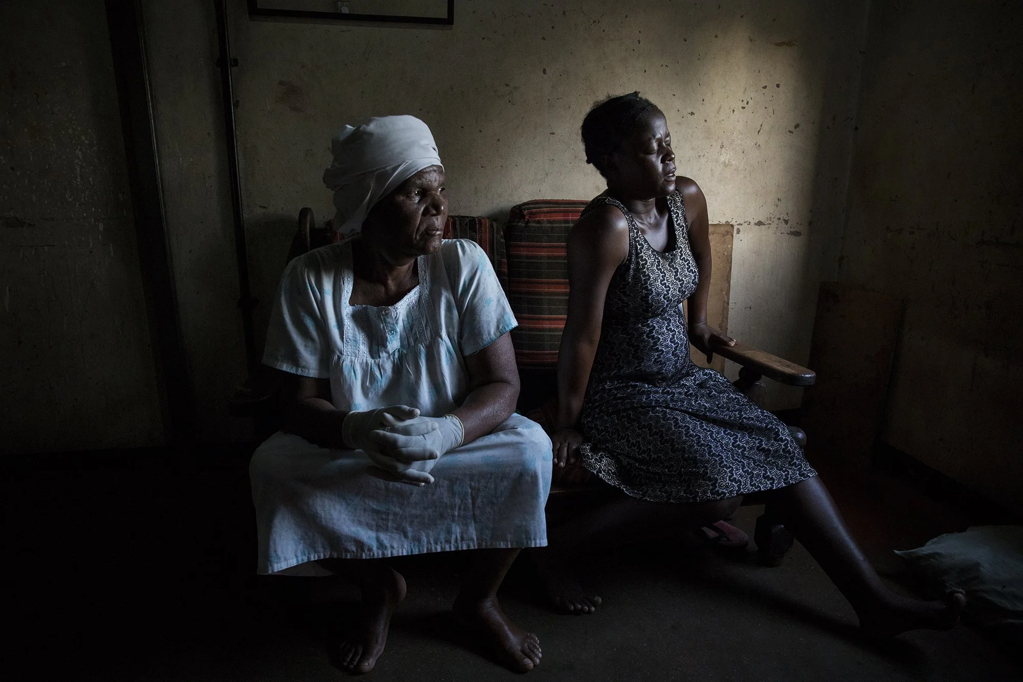 December 2, 2019 - Mbare: 72-year-old Esther Zinyoro looks on while Winnet Nengomasha experiences contractions. Gogo Gwena referred Winnet Nengomasha to a private hospital as she required surgical delivery. Gogo Gwena is a traditional birth attendan