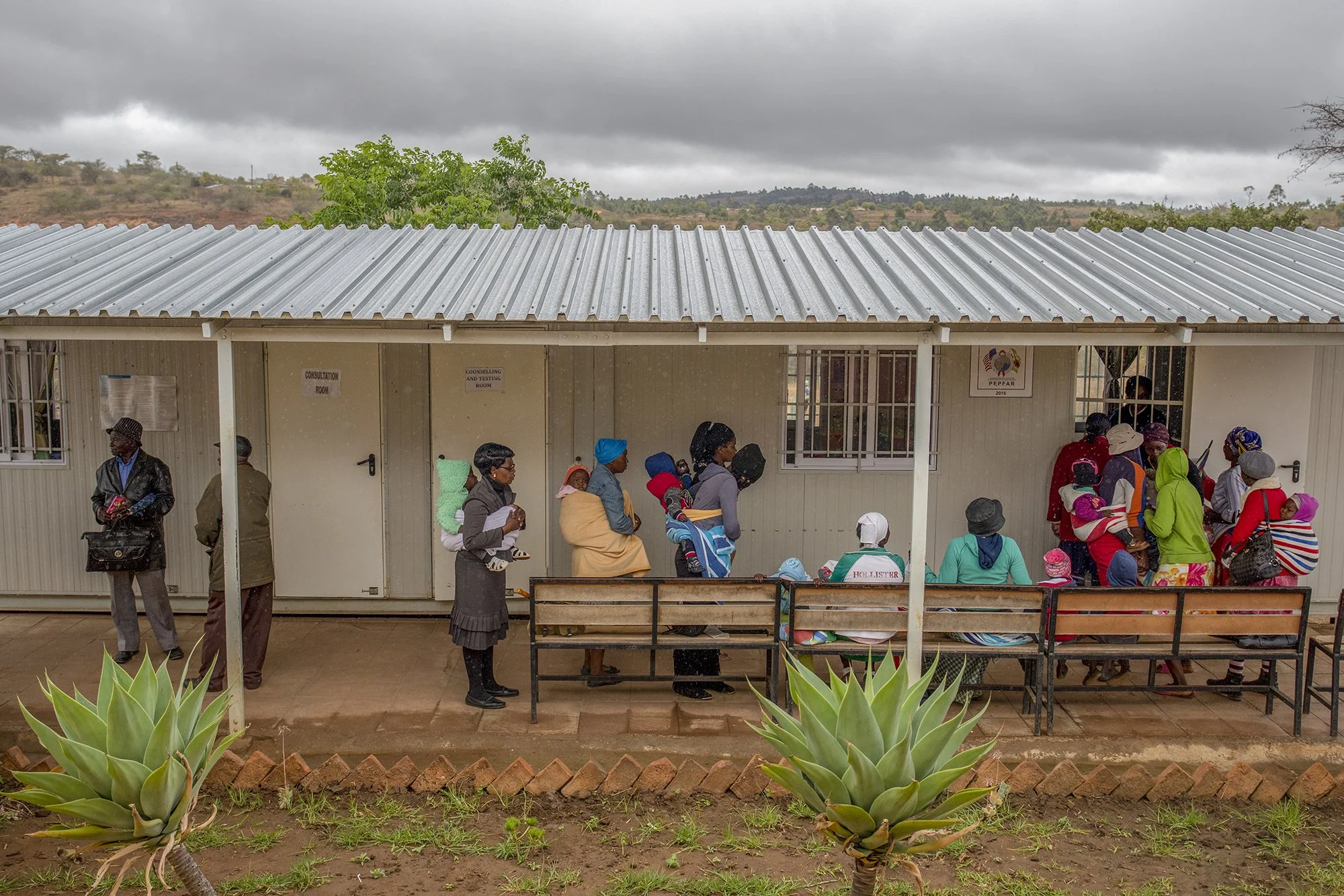 Women wait to access health services at Sakupwanya Clinic in Mutasa District, in Zimbabwe’s Manicaland Province during a nationwide campaign to vaccinate children against measles and rubella. - For PAI