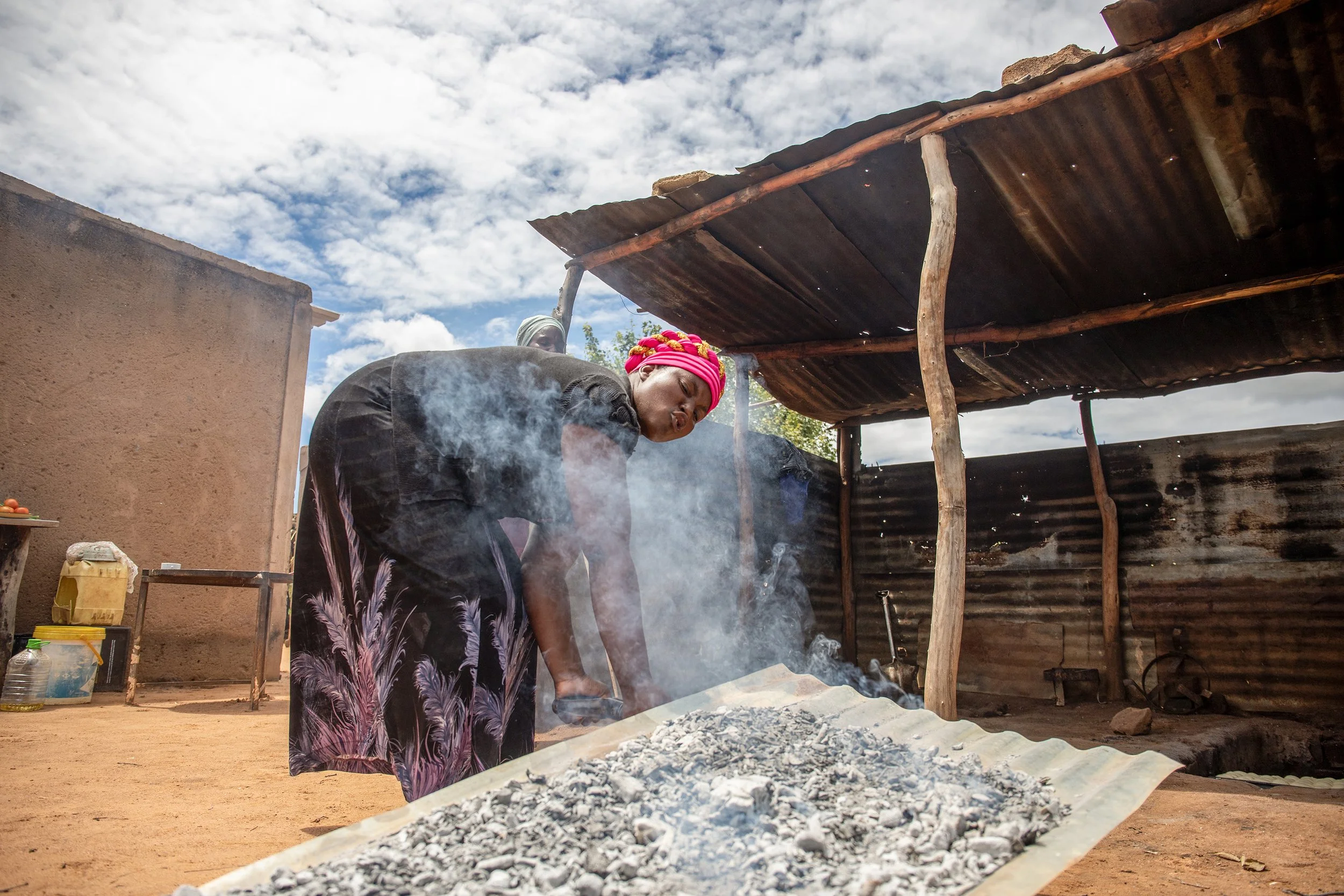  Nkele Dube, a member of the Learn and Do Group in Ward 22, prepares to bake tea buns. Founded in early 2024, this 10-member women’s collective operates a successful ISAL fund and manages a diverse business selling bread and poultry. Their efforts ar