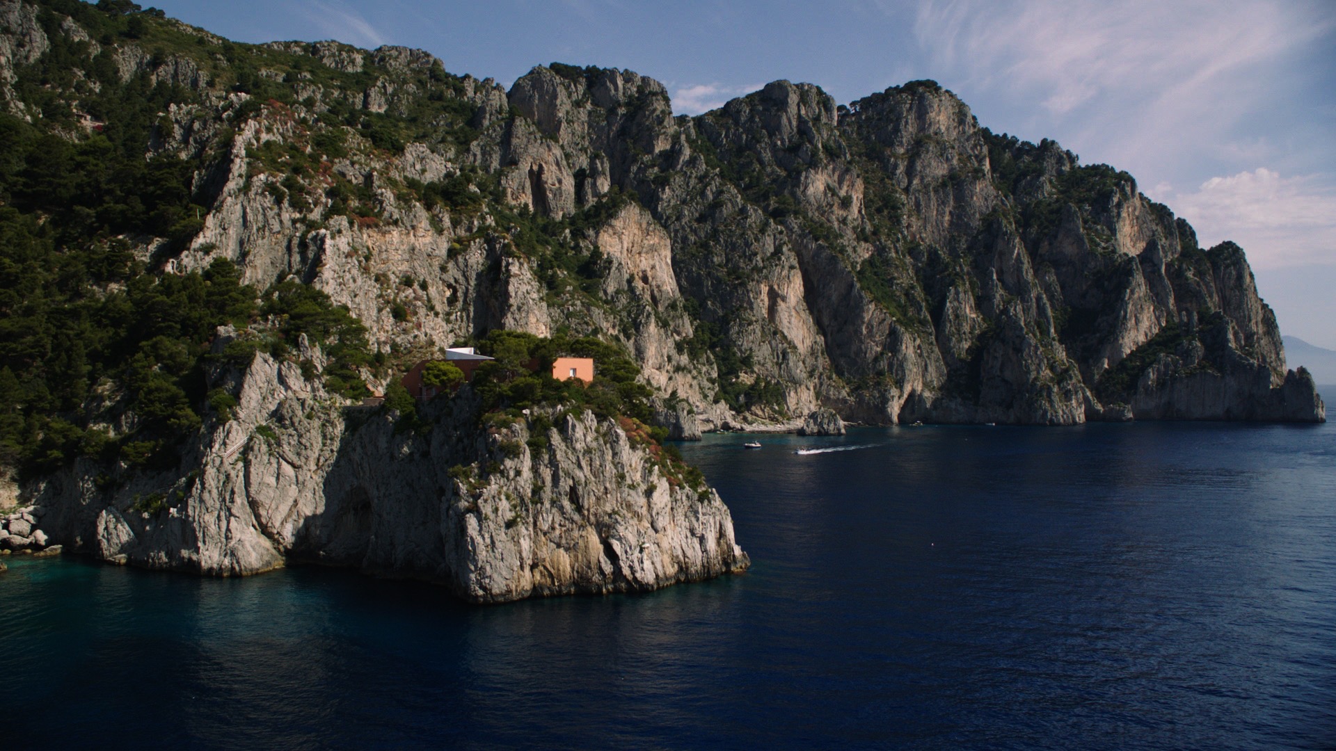 Built on the edge of the cliff, it is a brick box built to withstand stormy winters as the waves often reach the crest of the rock and slam the front of the house. The house is often used for serious study and writing and is still owned by Malaparte's family.