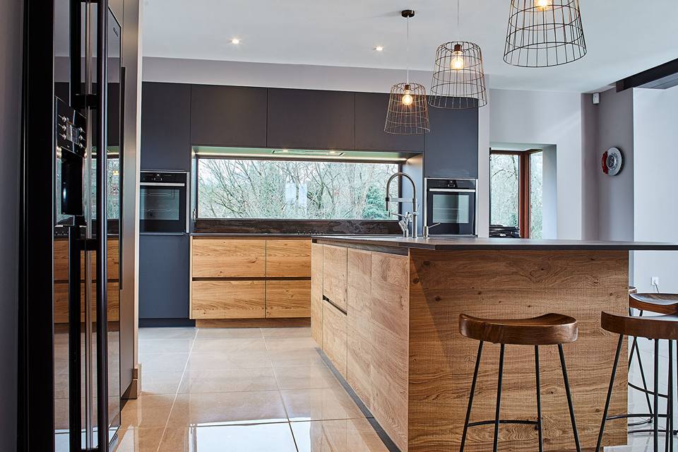  Copper accents with the light fixtures and the dark blue tones of the cabintry really bring the worktop and overall look of this project to life. 