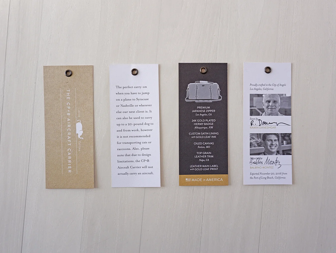 CUSTOM HANGTAGS WITH SPECIAL PANTONE GOLD INK AND ANTIQUE BRASS EYELETS. APPLIED WITH ROPE CORD.