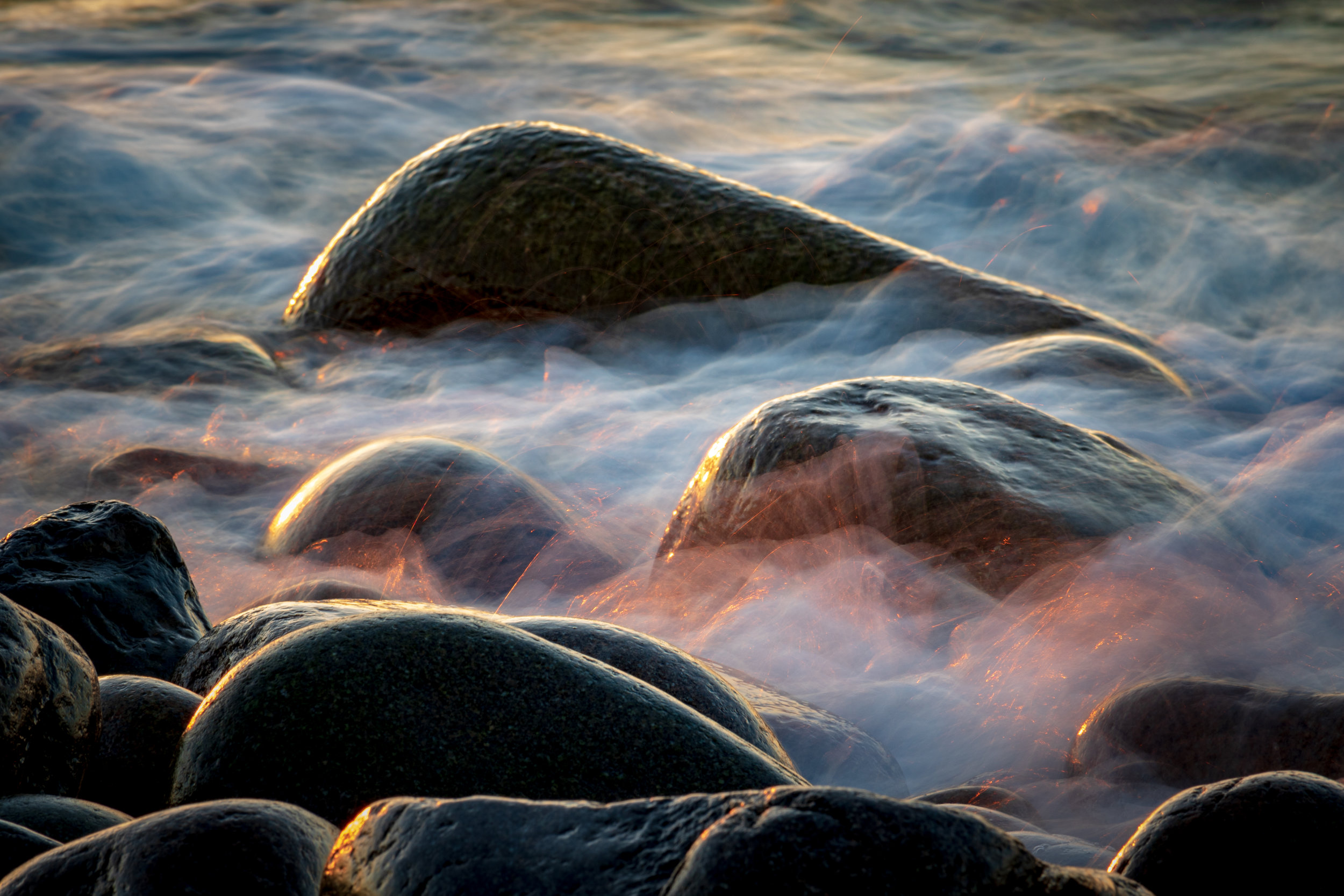  Long exposure of water flowing over the rocks at Boulder Beach in Acadia National Park.  Taken during sunrise. 