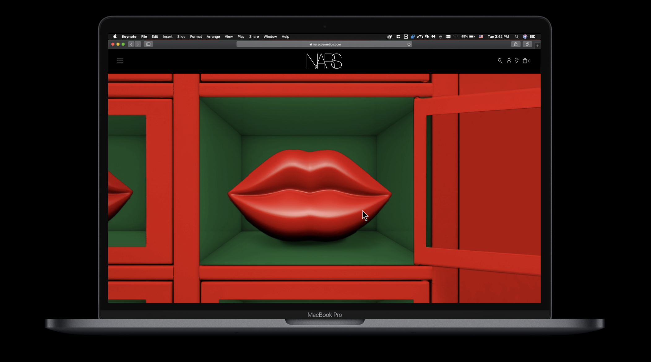 A MacBook Pro displaying a website with a digital art installation of red lips in a green and red cubical frame.
