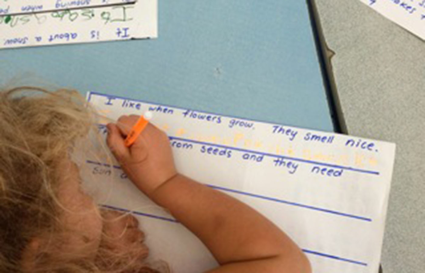 Kids writing at Learning at the Point Kindergarten