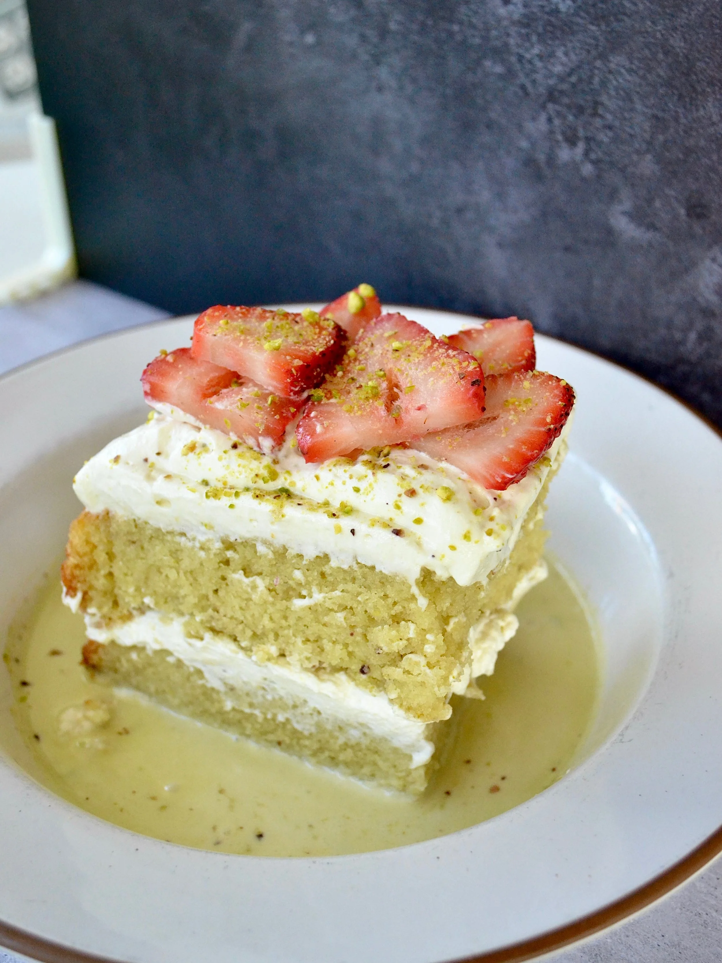 PISTACHIO TRES LECHES 🍰

Milk soaked sponge cake topped with pistachio coconut whipped cream &amp; fresh fruit 

Now on our everyday menu