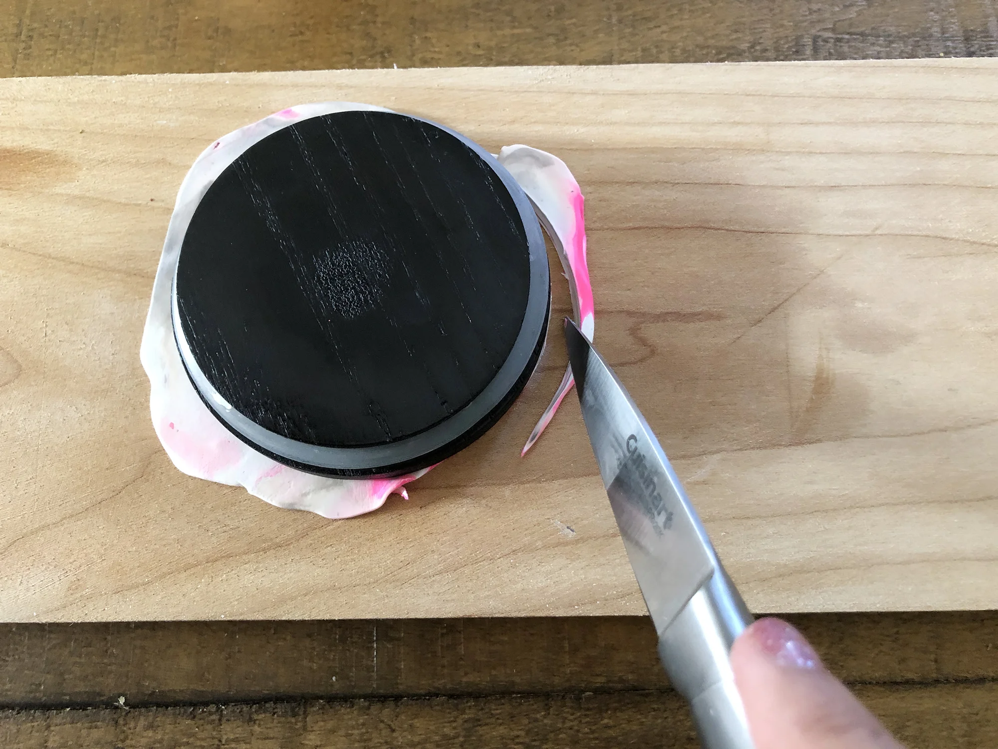 8. Find a flat, round item to help you cut your clay into a circle. You can use a cup, or int his case, my candle lid.