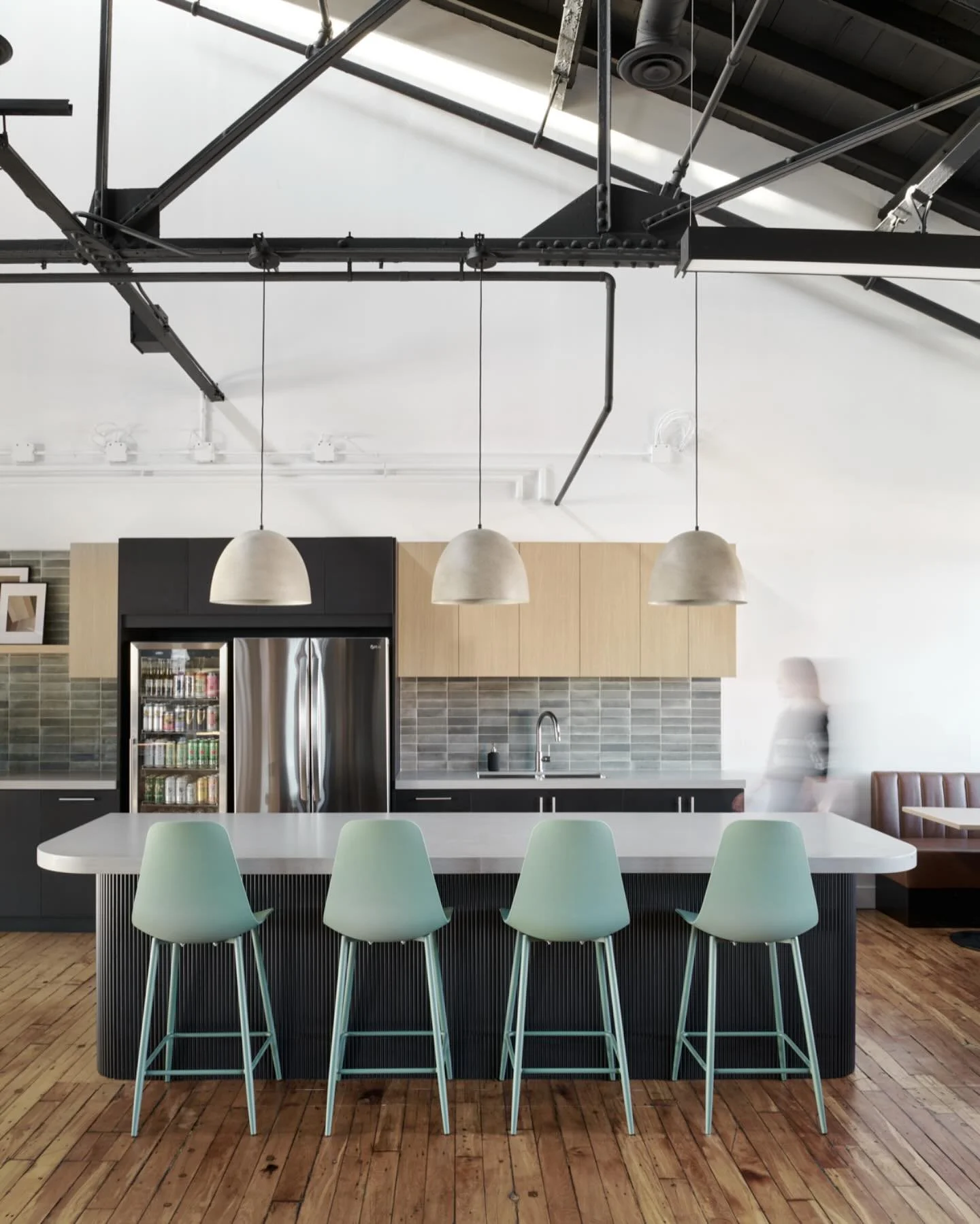 Part of the extended cafeteria for @isaacoperations. We echoed the bold black paint of the refreshed ceiling in the millwork (and other places) to make sure the space felt balanced, with breaks of light wood for warmth and some lively green tones for