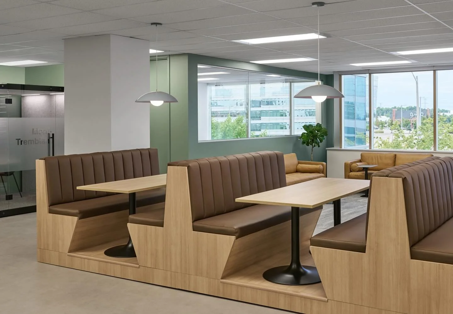 Collaboration space is key in the current office landscape, so we gave Just Energy&rsquo;s townhall area these raised booths to act as cozy dining tables and also a convenient gathering point. For more focused conversations there are glass quiet pods
