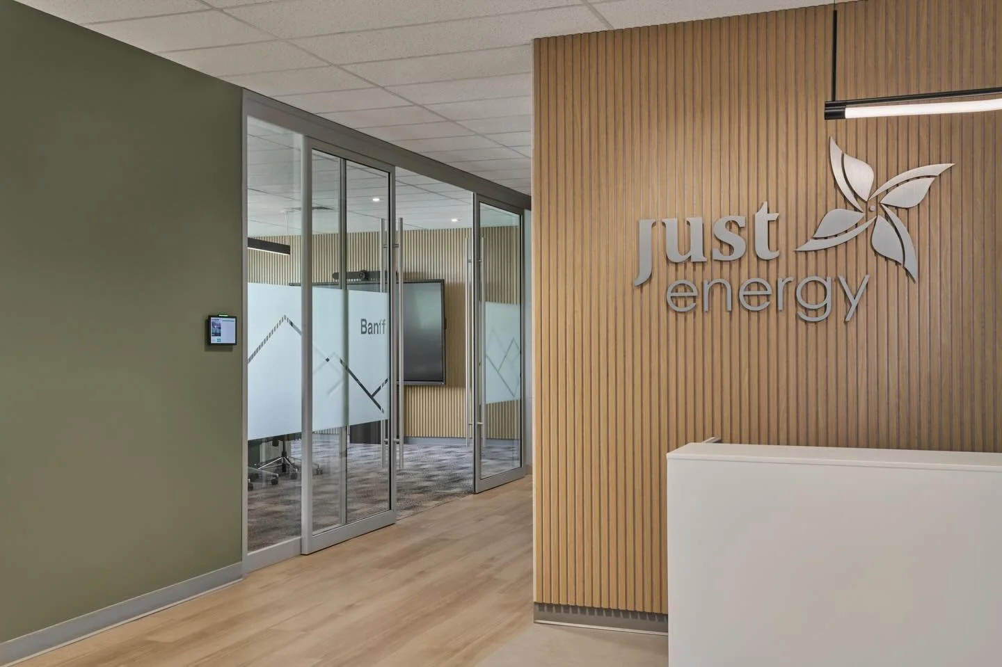 For Just Energy we took their logo colours of sapphire blue and lime green and translated them into a more earthy palette, reflecting natural energy sources. The sage green of the hallways gives an indirect splash of colour to the adjoining rooms, an