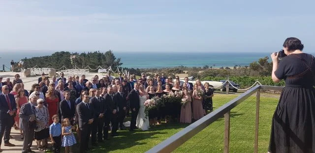 Mardy taking the post-ceremony group shot - how about that view? And can you spy Tom and Tayla in the back left corner still providing their fabulous music.