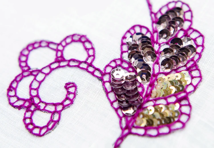 CHAINED SEQUIN: A hand embroidered sample created for a pervious Wemyss School of Needlework workshop lead by Chloe. This design was created using an archive pattern from the Weymss collection using chain stitch and sequins.