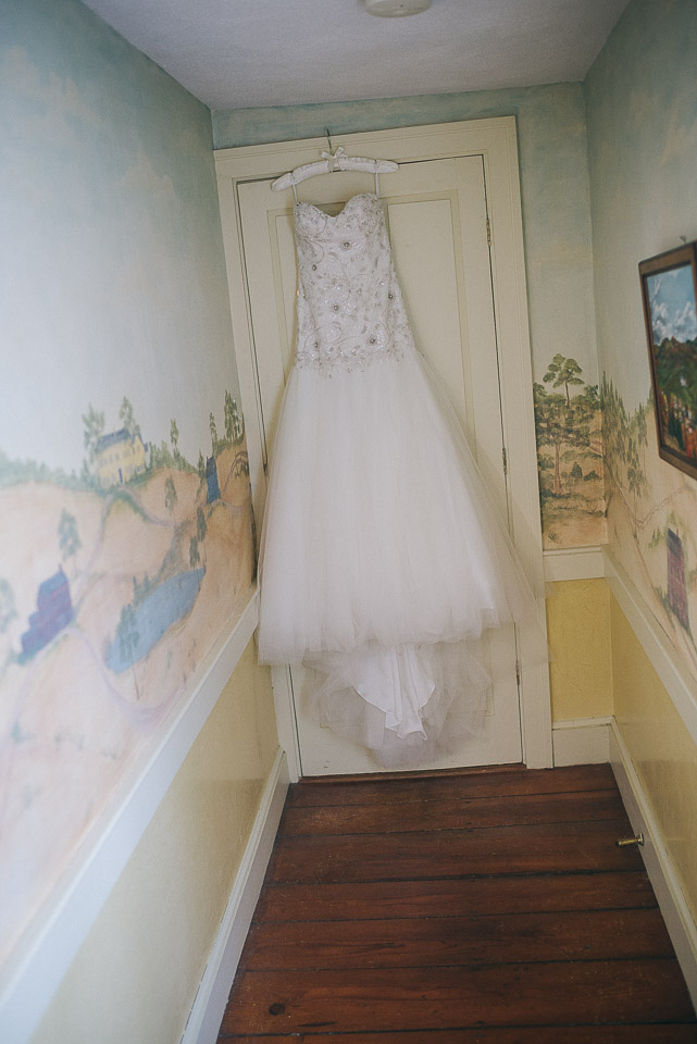 NH Wedding Photographer: dress hanging in hallway