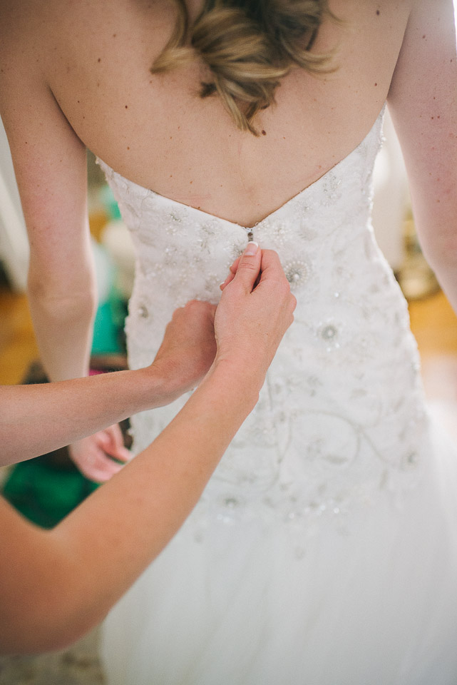NH Wedding Photographer: bride putting on dress