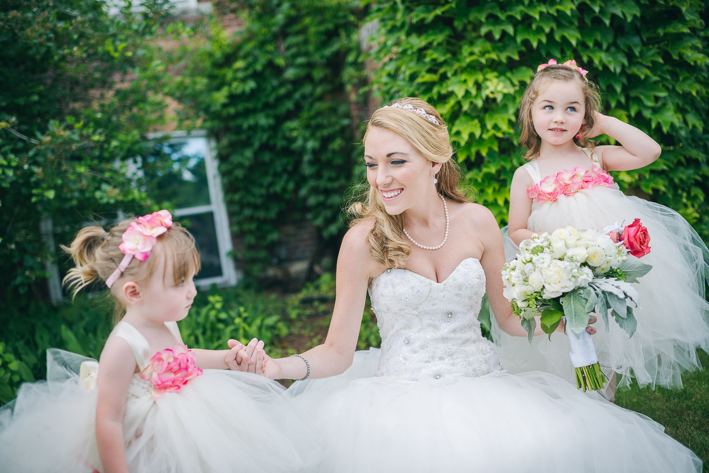 NH Wedding Photographer: flower girls with bride at Saint Anselm