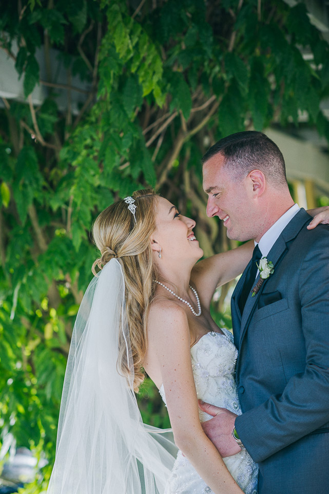 NH Wedding Photographer: newlyweds under pergola covered walkway